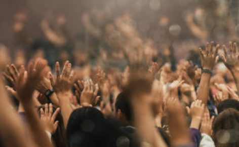 Christian worship with praise to God Ready to raise your hand at the Christian music concert, Holy City. copy space event